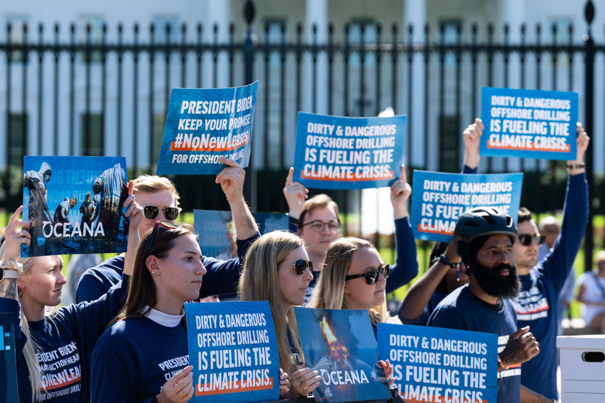 People hold signs reading "DIRTY AND DANGEROUS: OFFSHORE DRILLING IS FUELING THE CLIMATE CRISIS" during a protest in front of the white house