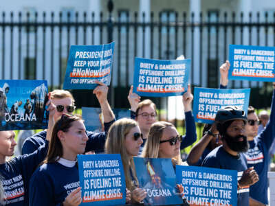 People hold signs reading "DIRTY AND DANGEROUS: OFFSHORE DRILLING IS FUELING THE CLIMATE CRISIS" during a protest in front of the white house