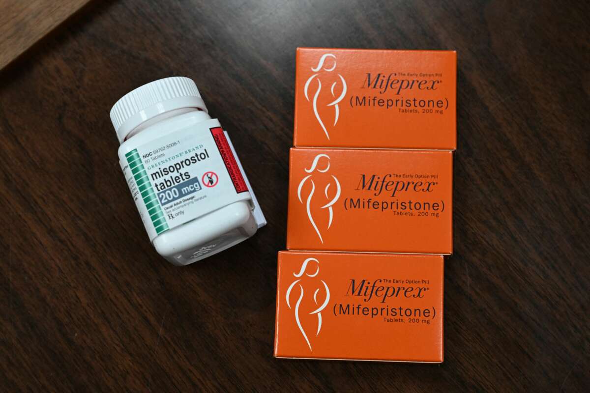Three boxes of Misoprostol are seen on a table next to a bottle of the same prescription drug