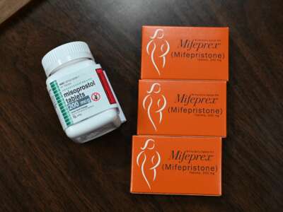 Three boxes of Misoprostol are seen on a table next to a bottle of the same prescription drug