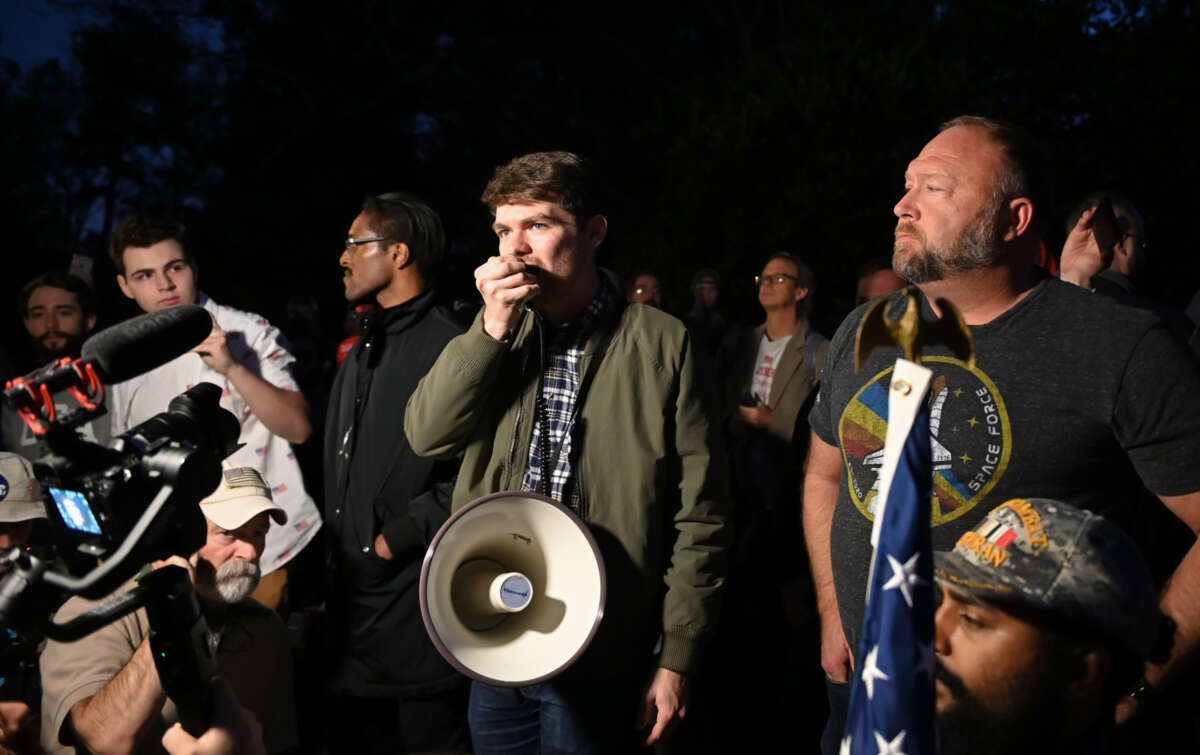 Nick Fuentes, Alex Jones and Ali Alexander are pictured during a 'Stop the Steal' broadcaster rally at the Governor's Mansion in Georgia on November 19, 2020.