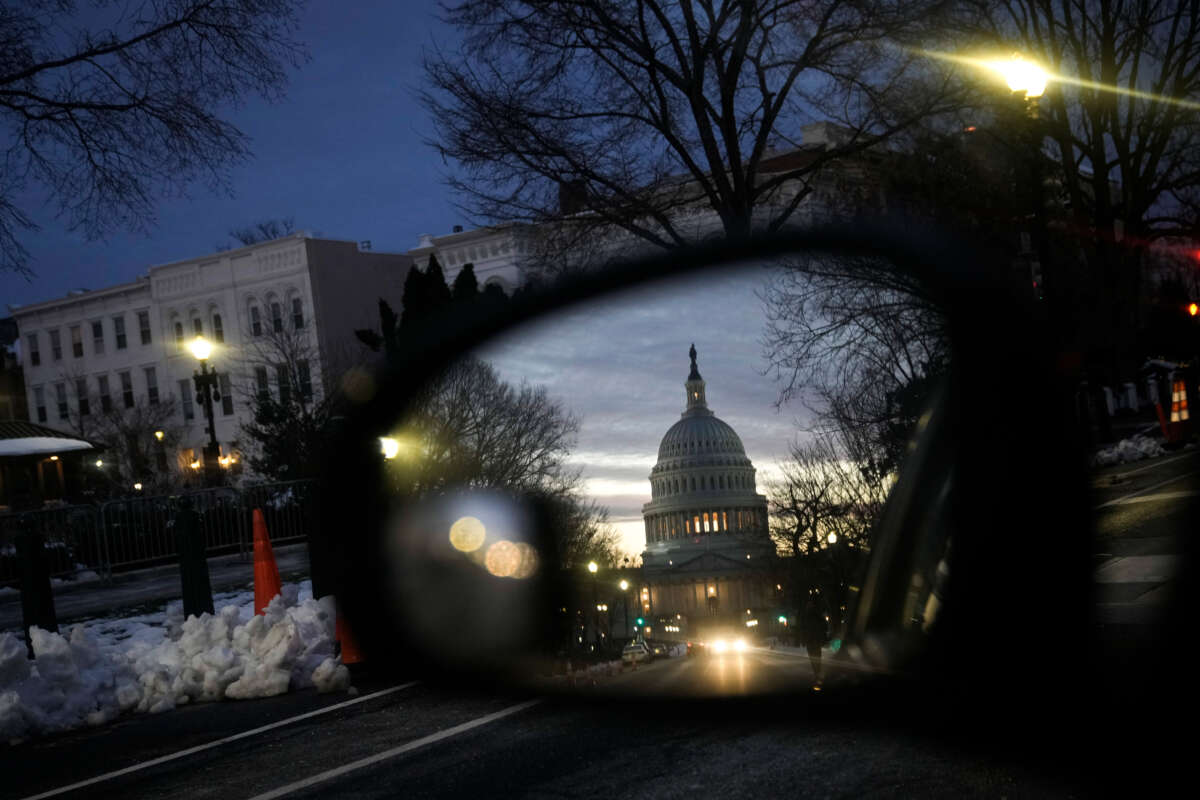 A view of the U.S. Capitol at sunset reflected in a car window on January 5, 2022, in Washington, D.C.