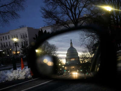 A view of the U.S. Capitol at sunset reflected in a car window on January 5, 2022, in Washington, D.C.