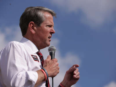 Gov. Brian Kemp speaks to voters during a campaign stop at Williamson Brothers Bar-B-Q on November 3, 2022, in Marietta, Georgia.