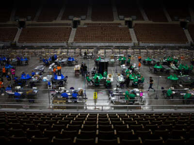 Contractors working for Cyber Ninjas, who was hired by the Arizona State Senate, examine and recount ballots from the 2020 general election at Veterans Memorial Coliseum on May 8, 2021, in Phoenix, Arizona.