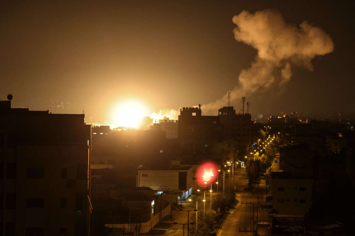 Fire and smoke rise above buildings in Gaza City as Israel launches airstrikes on the Palestinian enclave early on January 27, 2023.