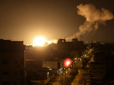 Fire and smoke rise above buildings in Gaza City as Israel launches airstrikes on the Palestinian enclave early on January 27, 2023.