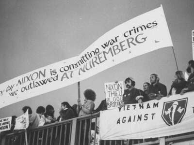 Antiwar demonstrators, including some Vietnam Veterans Against the War, hold banners denouncing the general war effort and President Richard Nixon specifically, outside a hotel where Nixon is holding a fundraising dinner on September 27, 1972.