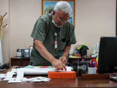 Dr. Franz Theard prepares doses of Mifepristone, the abortion pill, in his clinic in Santa Teresa, New Mexico on May 7, 2022.