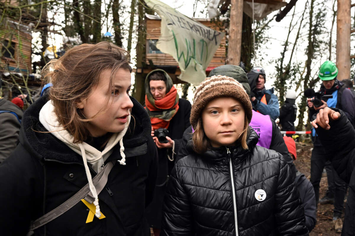 Climate activists Luisa Neubauer (L) and Greta Thunberg (R) stand on the third day of the eviction in the lignite hamlet of Lützerath occupied by climate activists in North Rhine-Westphalia, Germany, on January 13, 2023.