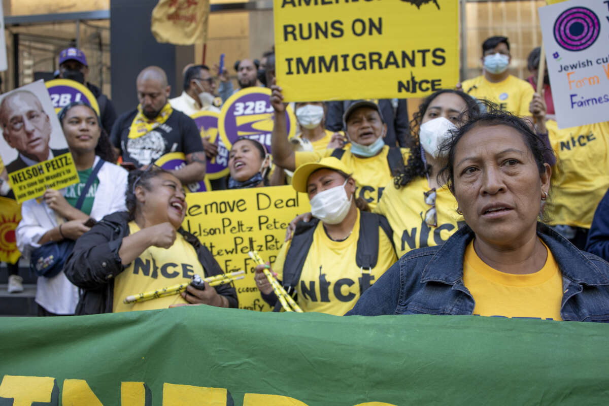 Farm workers with the Coalition of Immokalee Workers, and their supporters, call for a boycott of Wendy's outside of the Park Avenue offices of the chairman of Wendy's board, Nelson Peltz, on May 12, 2022 in New York City.