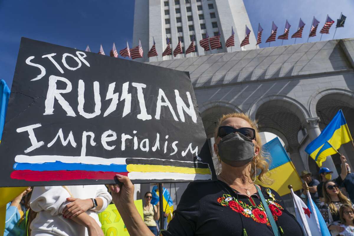 A protester holds a "Stop Russian Imperialism" sign at a rally in Los Angeles, California on March 19, 2022.