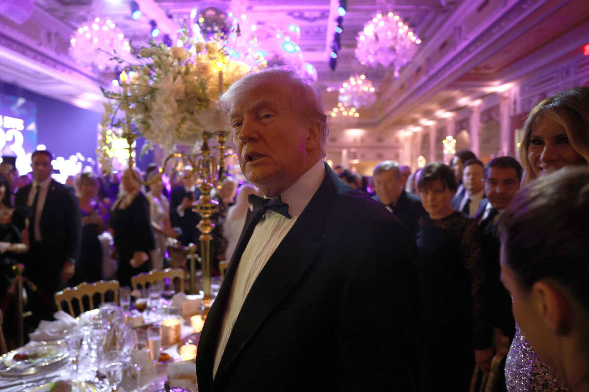 Donald Trump greets guests as he arrives for a New Years event at his Mar-a-Lago home on December 31, 2022 in Palm Beach, Florida.
