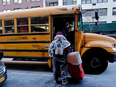 A migrant leaves the camp in front of the Watson Hotel after being evicted on February 1, 2023, in New York City.