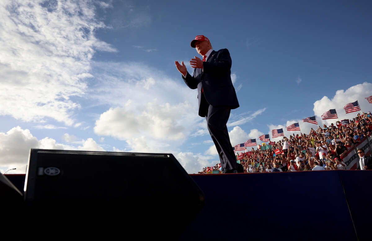 Former President Donald Trump walks on stage during a rally at the Miami-Dade Country Fair and Exposition on November 6, 2022, in Miami, Florida.