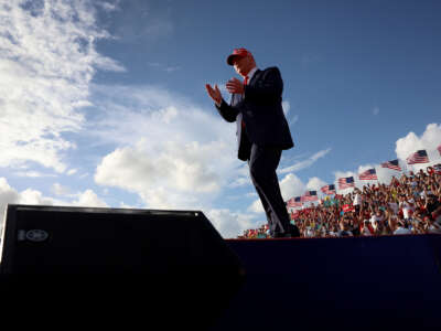 Former President Donald Trump walks on stage during a rally at the Miami-Dade Country Fair and Exposition on November 6, 2022, in Miami, Florida.