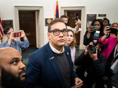 Reporters surround embattled Rep. George Santos as he heads to the House Chamber for a vote, at the U.S. Capitol on January 31, 2023, in Washington, D.C.