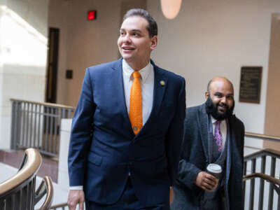 Rep. George Santos, left, and aide Vish Burra are seen in the Capitol Visitor Center after a meeting of the House Republican Conference on February 7, 2023.