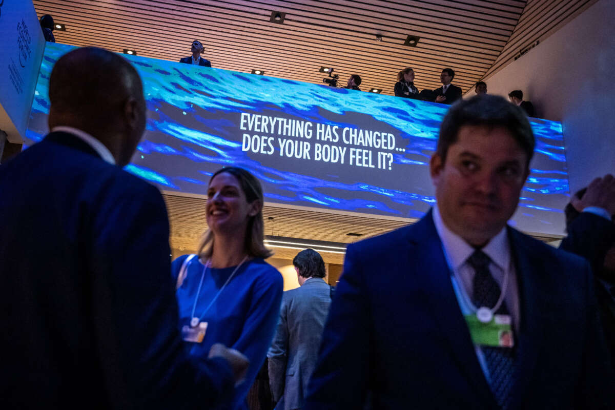 Participants of the World Economic Forum (WEF) stand in the Congress centre during the WEF's annual meeting in Davos on January 18, 2023.