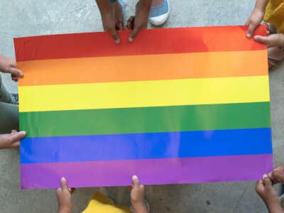 Youths hold lgbt pride flag