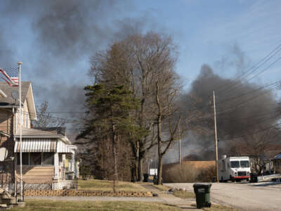 Smoke rises from a derailed cargo train in East Palestine, Ohio, on February 4, 2023.