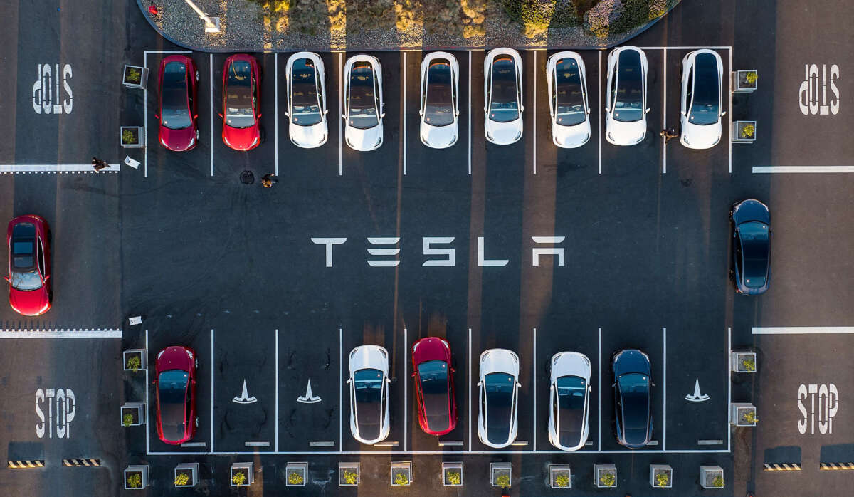 An aerial view shows cars parked at the Tesla Fremont Factory in Fremont, California, on February 10, 2022.