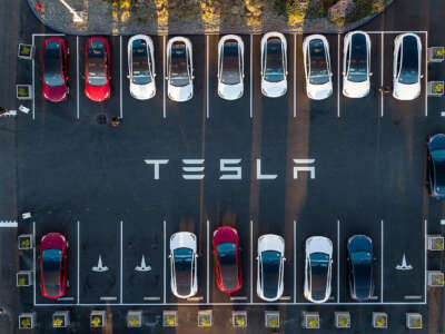 An aerial view shows cars parked at the Tesla Fremont Factory in Fremont, California, on February 10, 2022.