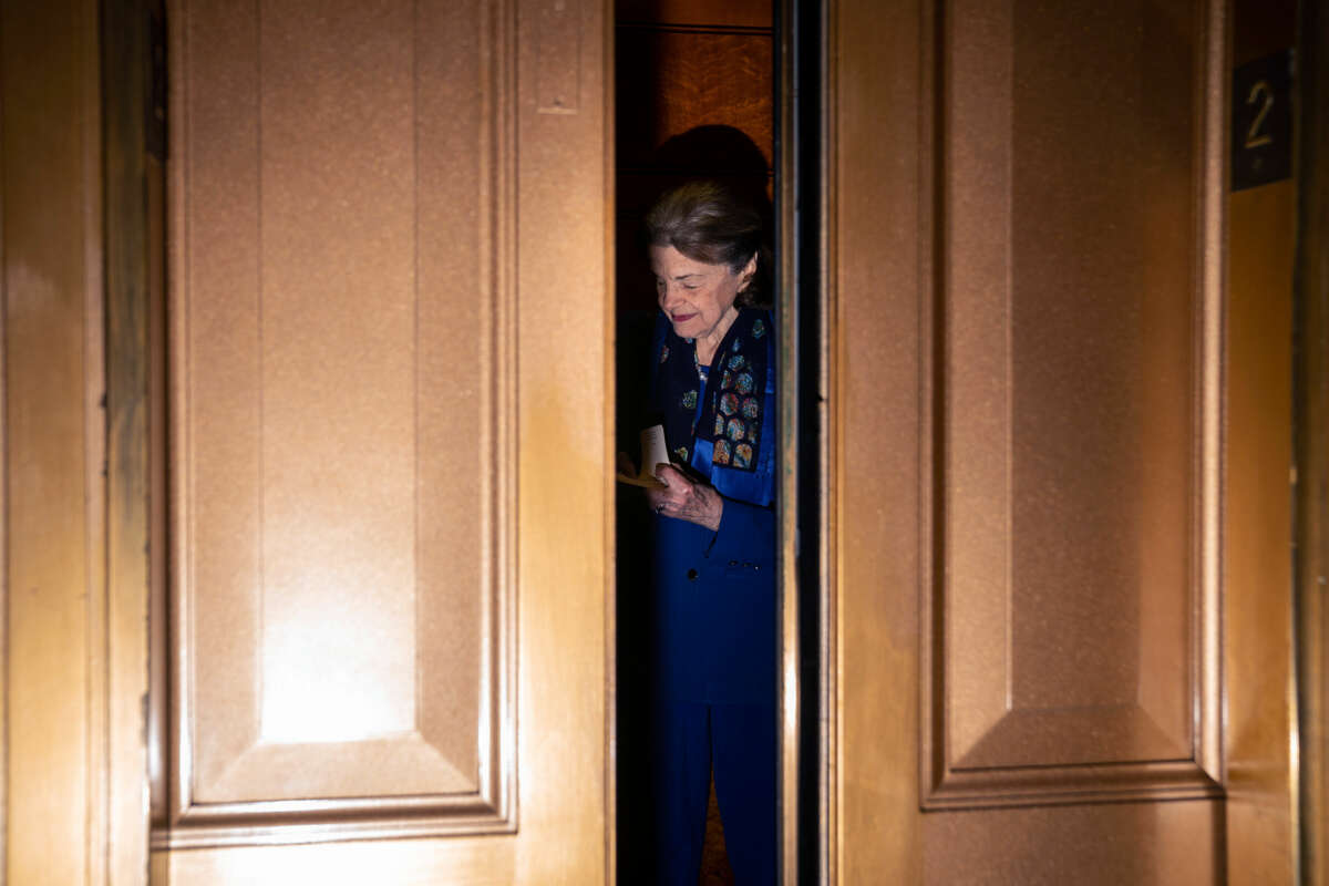 Dianne Feinstein stands in an elevator as the doors close