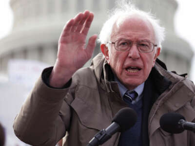 Bernie Sanders gestures while speaking at a podium on the steps of the United States capitol