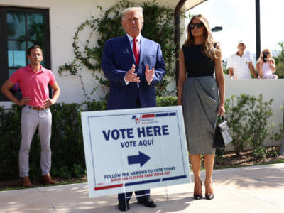 Former President Donald Trump stands with former first lady Melania Trump as he speaks to the media after voting at a polling station setup in the Morton and Barbara Mandel Recreation Center on November 8, 2022, in Palm Beach, Florida.