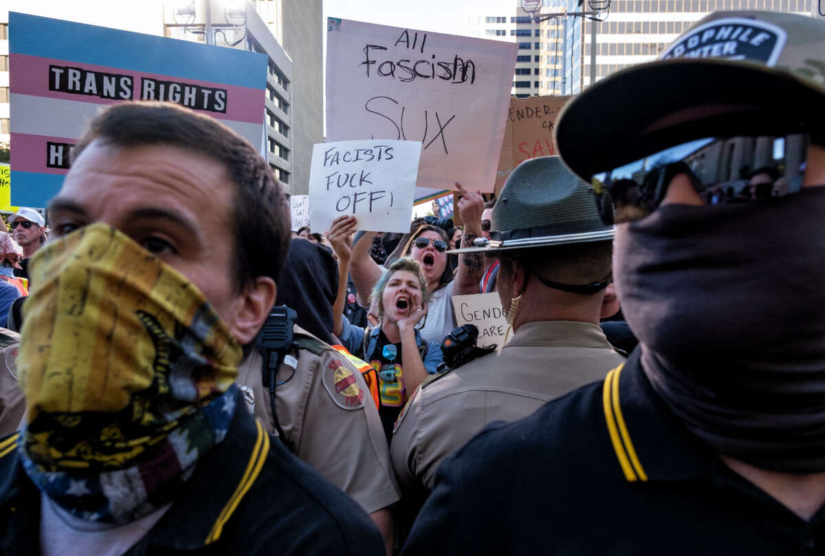 Tennessee State Police stand between members of the Proud Boys and counterprotesters during a protest against gender-affirming care by Vanderbilt University Medical Center, at the War Memorial Plaza in Nashville, Tennessee, on October 21, 2022.