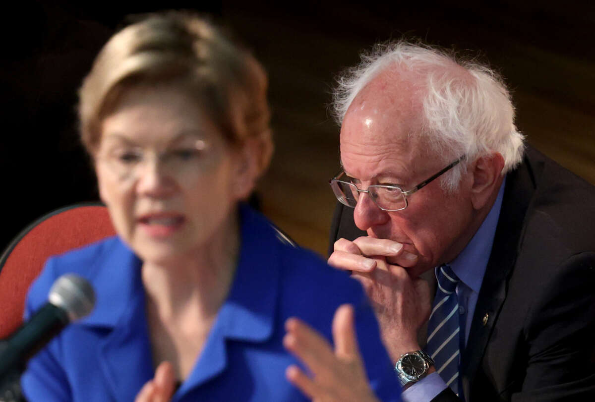 Sen. Bernie Sanders, right, listens as Sen. Elizabeth Warren speaks at the Ministers’ Breakfast hosted by National Action Network and Rev. Al Sharpton on February 26, 2020, in North Charleston, South Carolina.