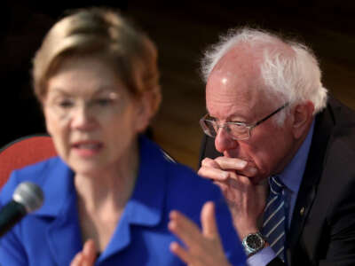 Sen. Bernie Sanders, right, listens as Sen. Elizabeth Warren speaks at the Ministers’ Breakfast hosted by National Action Network and Rev. Al Sharpton on February 26, 2020, in North Charleston, South Carolina.