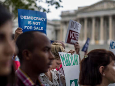 Lawmakers gather along with lobbying groups, for a press conference to discuss a constitutional amendment on campaign finance reform overturning Citizens United on Capitol Hill in Washington, D.C., on September 8, 2014.