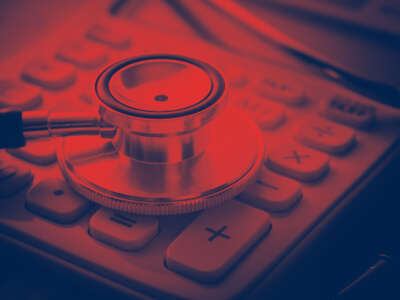 Stethoscope on calculator in red and blue