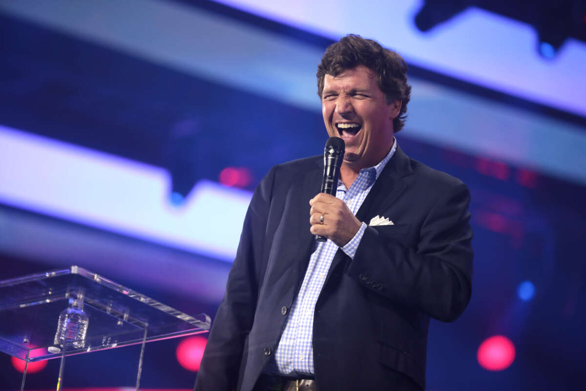 Tucker Carlson speaks with attendees at the 2022 AmericaFest at the Phoenix Convention Center in Phoenix, Arizona.