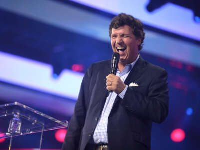 Tucker Carlson speaks with attendees at the 2022 AmericaFest at the Phoenix Convention Center in Phoenix, Arizona.