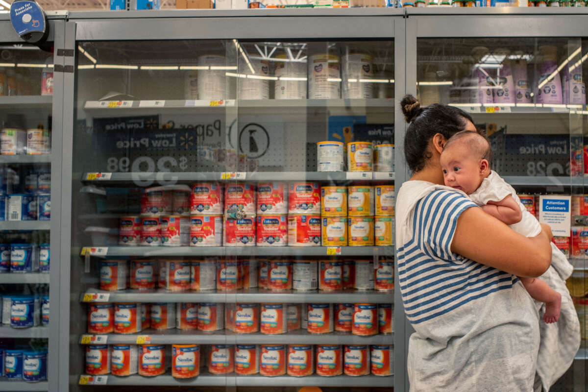 A family waits to receive baby formula in a Walmart Supercenter on July 8, 2022, in Houston, Texas.