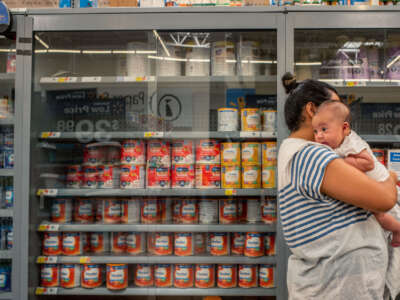 A family waits to receive baby formula in a Walmart Supercenter on July 8, 2022, in Houston, Texas.