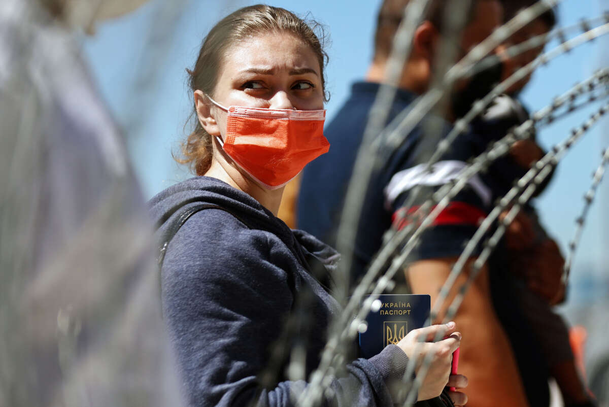 A person from Ukraine holds their Ukrainian passport before being allowed to cross the San Ysidro Port of Entry into the United States to seek asylum on March 22, 2022, in Tijuana, Mexico.