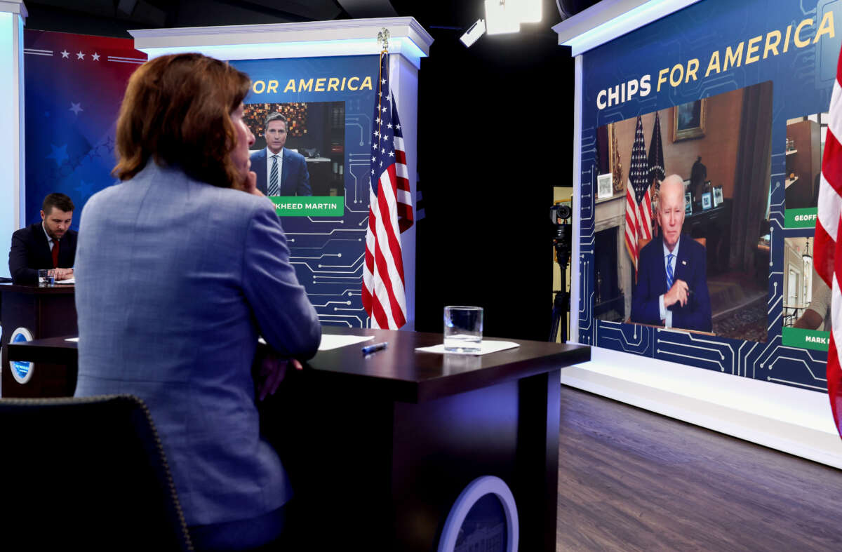 Secretary of Commerce Gina Raimondo listens as President Joe Biden participates virtually in a meeting on the Creating Helpful Incentives to Produce Semiconductors (CHIPS) for America Act, in the South Court Auditorium at the White House on July 25, 2022, in Washington, D.C.