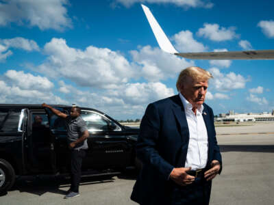 Former President Donald Trump boards his airplane at Palm Beach International Airport on February 22, 2023, in West Palm Beach, Florida.