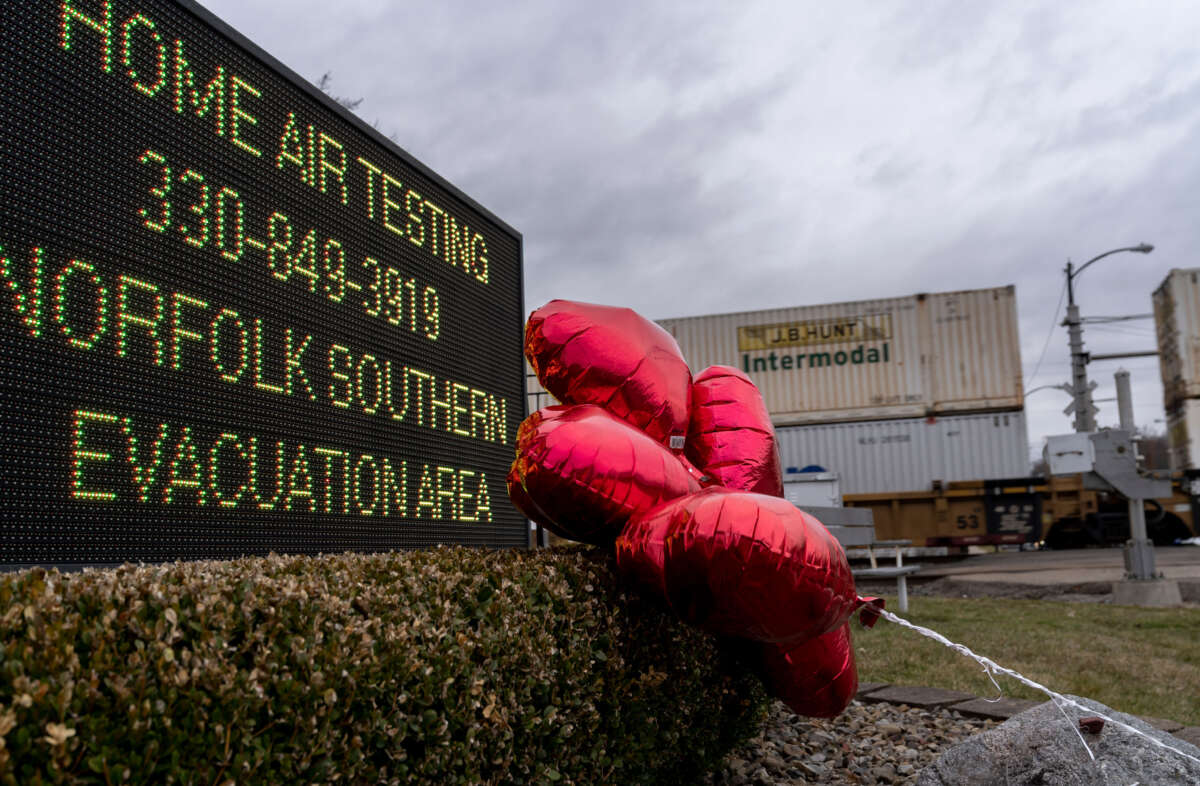 Balloons are placed next to a sign displaying information for residents to receive air-quality tests from Norfolk Southern Railway on February 16, 2023, in East Palestine, Ohio.