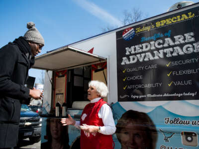 Carol Berman, of West Palm Beach, Florida, speaks with pedestrians about Medicare Advantage during the Coalition for Medicare Choices' Medicare Advantage Food Truck stop on North Capitol Street in Washington, D.C., on March 9, 2015.