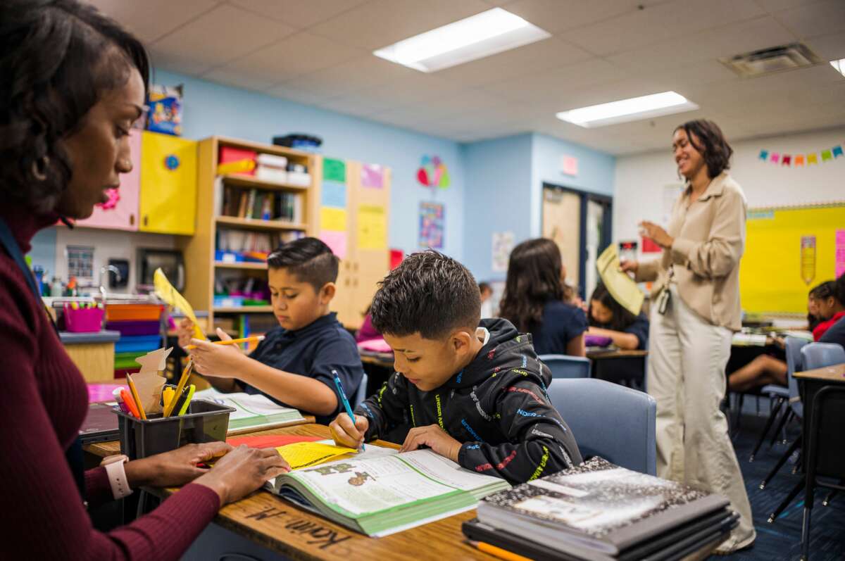 Aisha Thomas (L) learns teaching skills in her classroom in Nevitt Elementary School, in Phoenix, Arizona, on October 26, 2022.