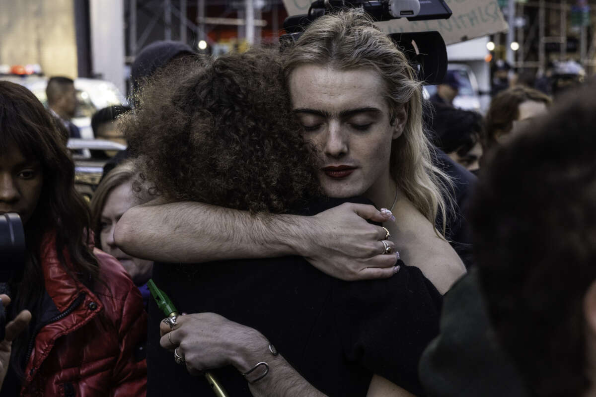 Counter-protesters for transgender rights hug during a protest on November 14, 2022 in New York City.