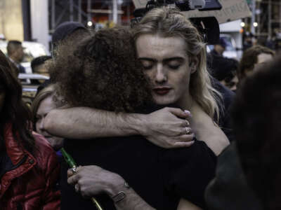 Counter-protesters for transgender rights hug during a protest on November 14, 2022 in New York City.