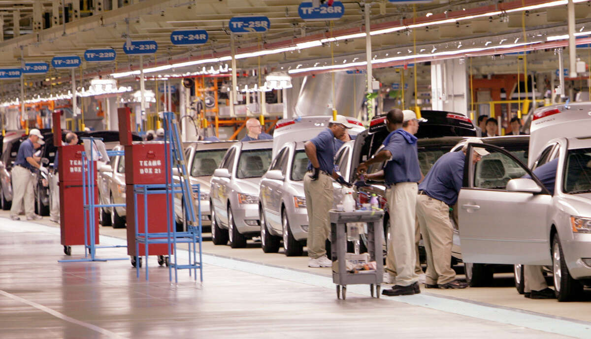Cars rolls down the assembly line during the grand opening ceremony of the Hyundai plant in Montgomery, Alabama on May 20, 2005.