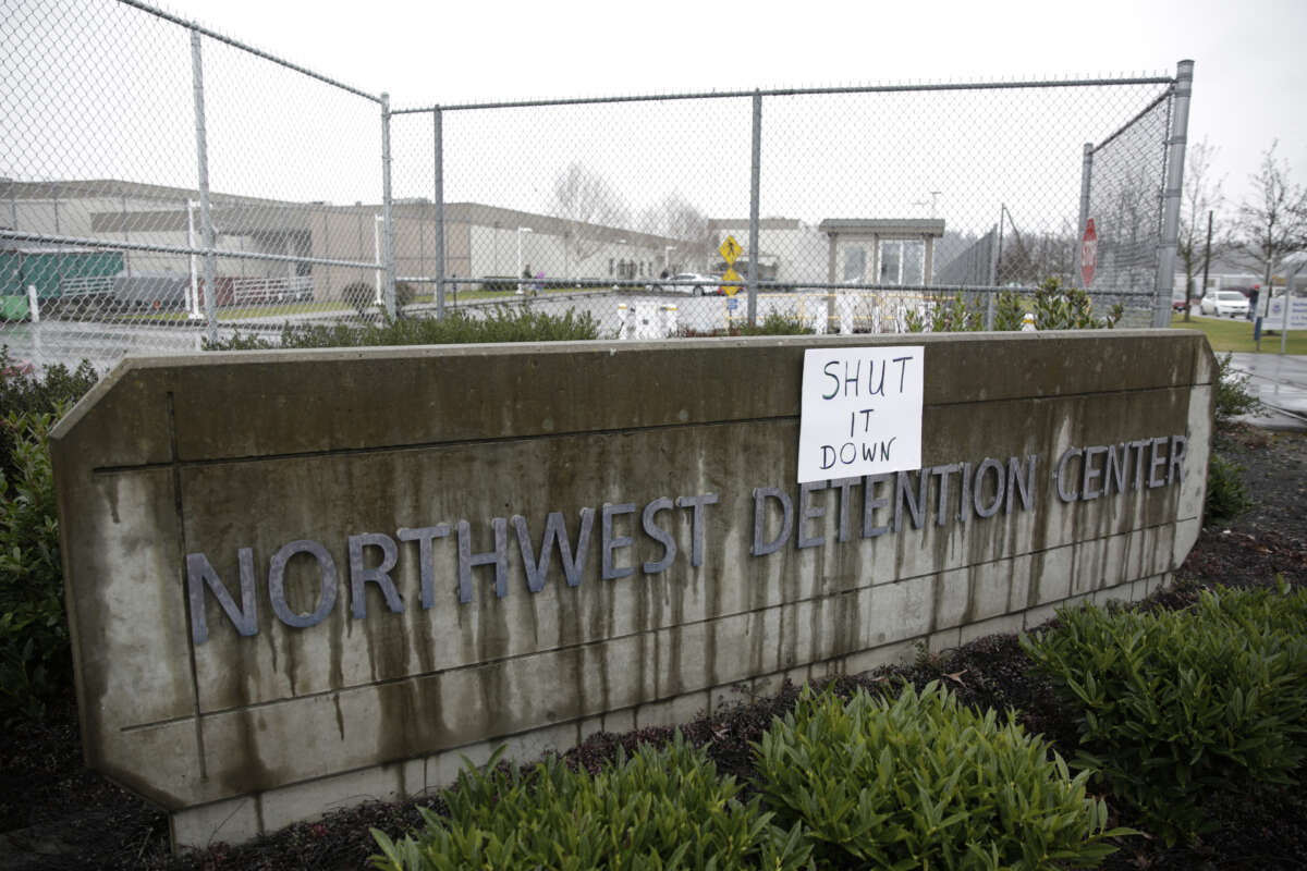 A sign saying "shut it down" outside of the Northwest Detention Center in Washington