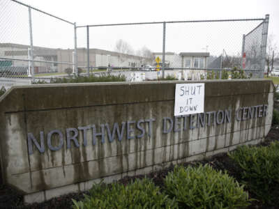 A sign saying "shut it down" outside of the Northwest Detention Center in Washington